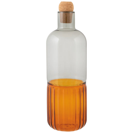 Two-toned glass bottle with cork stopper on a white background
