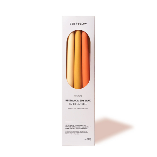 Box of Ebb & Flow candles with a gradient design on a white background